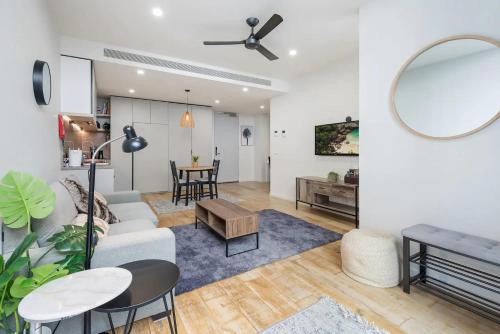 a living room with a couch and a table at Stylish One BD Hideaway in Essendon in Melbourne