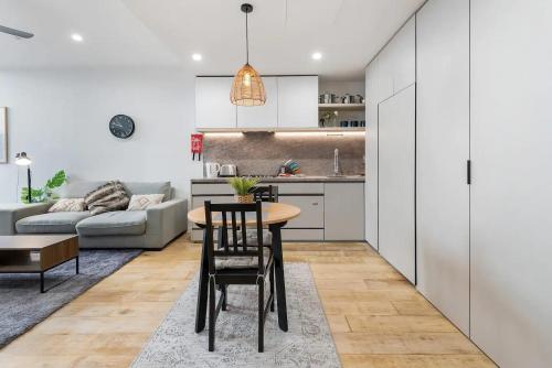 a kitchen and living room with a table and chairs at Stylish One BD Hideaway in Essendon in Melbourne