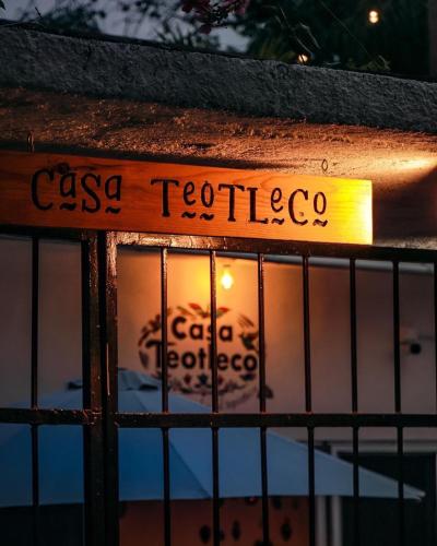 a sign that reads casa tequila is seen through a fence at Hospedaje Casa Teotleco in Tepoztlán