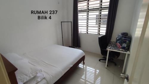 a small bedroom with a bed and a window at Homestay Kolam Renang Sungai Petani in Sungai Petani