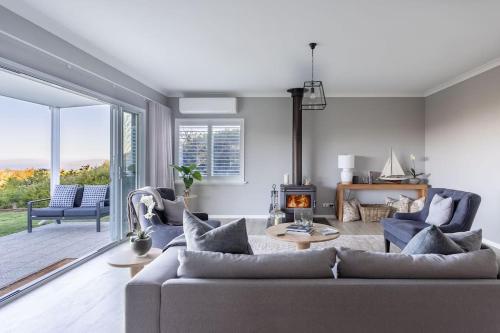 a living room with a couch and a fireplace at Belvoir - Denmark in Denmark