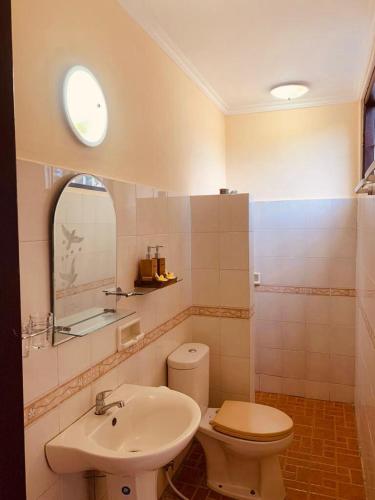 a bathroom with a toilet and a sink at Giri's Villa Jimbaran in Jimbaran