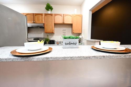 a kitchen with two plates on a counter at Modern Luxury, Sleeps 5, Near Universities,Airport 15mins,Free Parking in Philadelphia