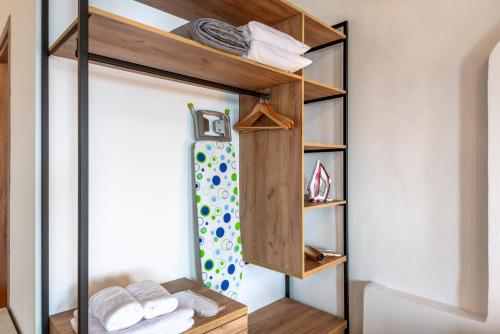 a bathroom with a closet with wooden shelves at Superb apartmentS Kriaras sea view in Sfakia in Khóra Sfakíon