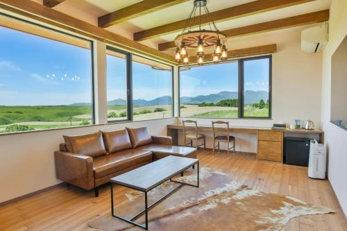 a living room with a couch and a table at El Patio Ranch in Aso