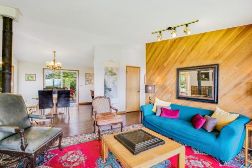 a living room with a blue couch and a table at Shangri Lodge Serene Retreat in Clinton