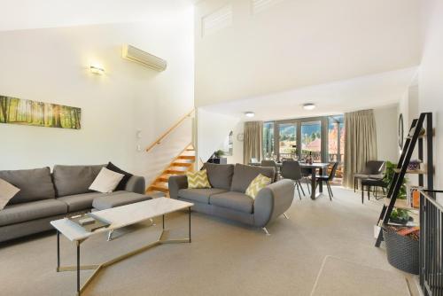 a living room with a couch and a table at *** LAKE VILLA 467 *** in Hanmer Springs