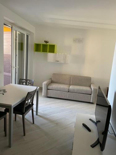 a living room with a couch and a table at Residence Verde Mare in Massignano