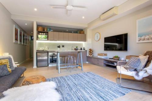 a living room with a couch and a kitchen at Dunn Bay Apartment 4 I Private Properties in Dunsborough