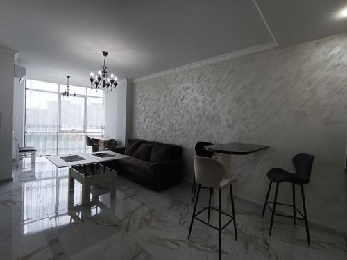 a living room with a couch and a table and chairs at Apartment in centre of Yerevan in Yerevan