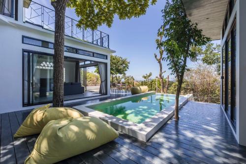 an external view of a house with a swimming pool at Pahili Pool Villas - SHA Plus in Ko Tao