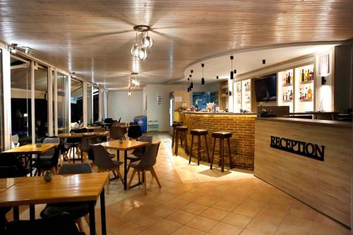 a restaurant with tables and chairs and a bar at Akis Studios Alykes in Alykes