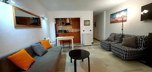 a living room with a couch and a table at Primera línea de playa in Marbella