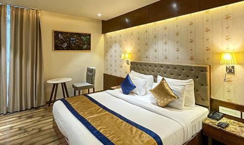 a hotel room with a bed and a table at FabHotel Prime The Wish in Jaipur