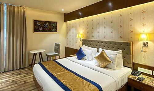 a hotel room with a large bed and a desk at FabHotel Prime The Wish in Jaipur