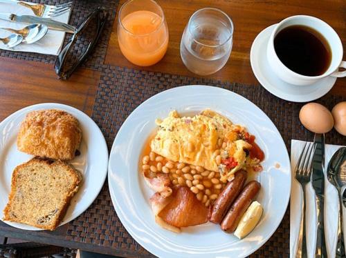 a table with a plate of breakfast food and coffee at The Crow's Nest Resort Fiji in Korotogo