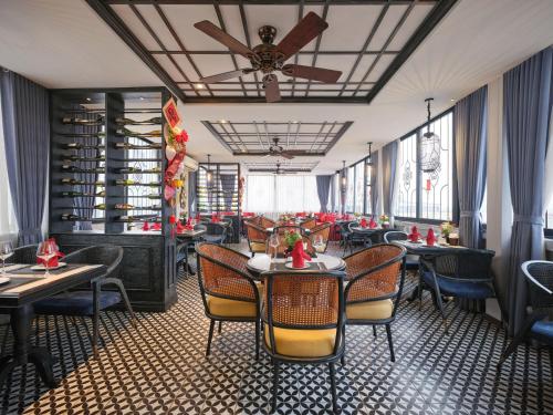 a restaurant with tables and chairs and a ceiling at Shining Central Hotel & Spa in Hanoi
