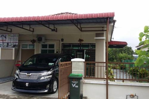 a car parked in front of a house at Cozy Homestay in Central Pokok Sena in Pokok Sena