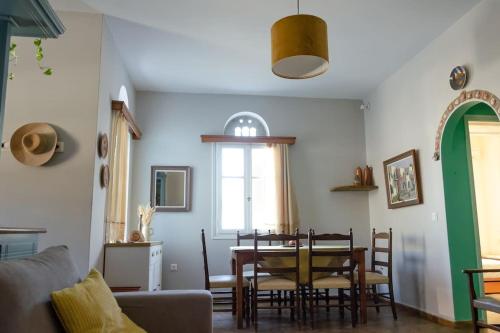 a living room with a table and a dining room at m͟͞a͟͞t͟͞a͟͞t͟͞h͟͞i͟͞a͟͞ GuestHouse Tinos in Triandáros