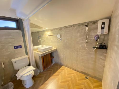 a bathroom with a toilet and a sink and a shower at ANANTAYA CHIANGMAI BOUTIQUE HOTEL in Chiang Mai