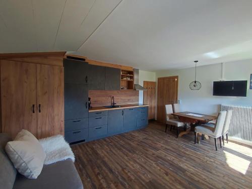 a kitchen with a bed and a table in a room at Haus Alpina in Berwang