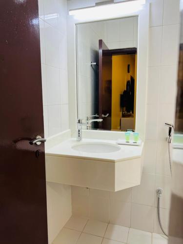a bathroom with a sink and a mirror at DANA HOTEL-Clock Tower Sharjah in Sharjah