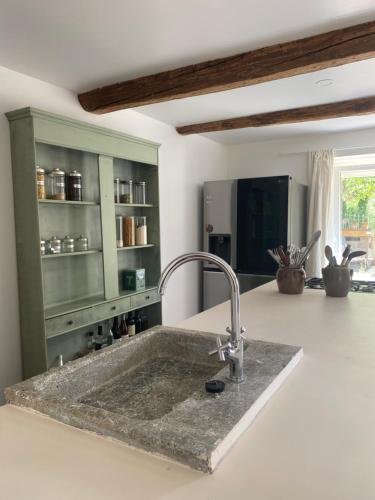 a kitchen counter with a sink in a kitchen at Mas des garrigues in Bouchet