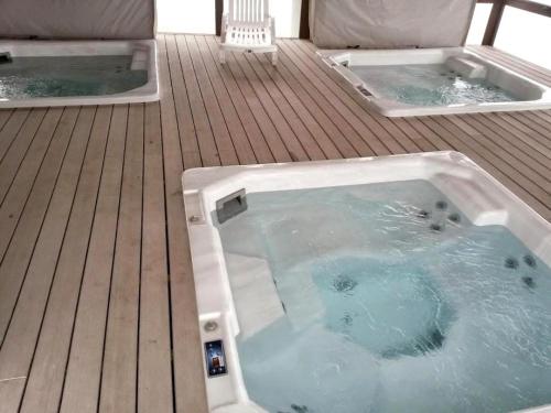a jacuzzi tub on top of a wooden deck at Jardin del Mar SPA & Enjoy in Coquimbo