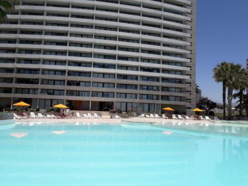 a large swimming pool in front of a large building at Jardin del Mar SPA & Enjoy in Coquimbo