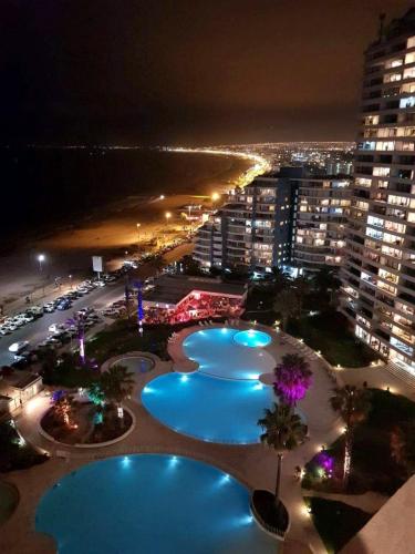 a view of three swimming pools at night at Jardin del Mar SPA & Enjoy in Coquimbo
