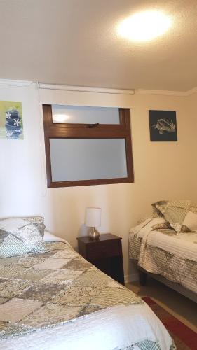 a bedroom with two beds and a window at Jardin del Mar SPA & Enjoy in Coquimbo