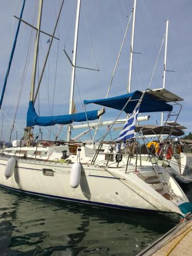 a white boat is docked in the water at Αναστασία in Nydri