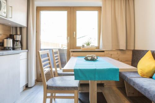a kitchen and dining room with a table and chairs at Landhaus Fiegl in Sölden