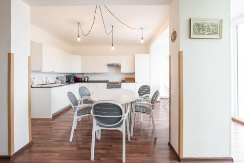 a kitchen and dining room with a table and chairs at Czech Family Home in Český Krumlov