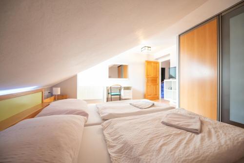a row of three beds in a room at Czech Family Home in Český Krumlov
