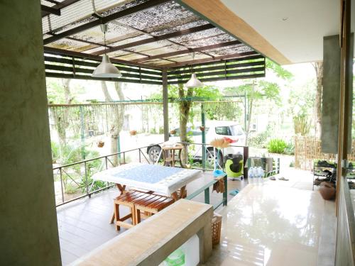 a patio with a table and chairs on a balcony at Time Pala-U Garden Villa (Noncee House) in Ban Pa Lau