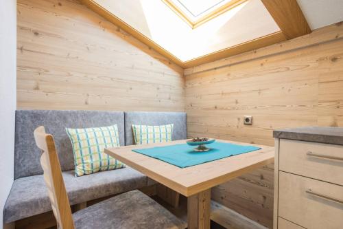 a dining room with a table and a skylight at Landhaus Fiegl in Sölden