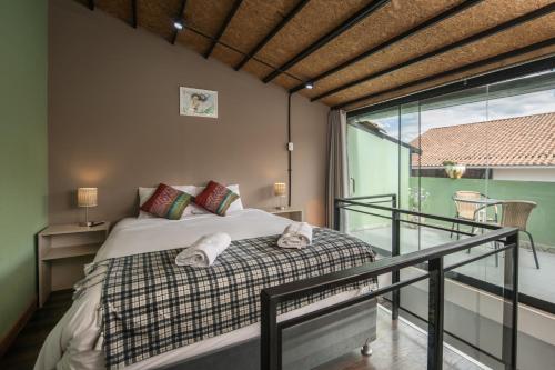 a bedroom with a bed and a balcony at Casa Cavassa Centro Histórico Cusco in Cusco