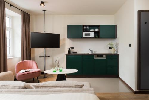 a living room with green cabinets and a table at master Mirabell in Salzburg
