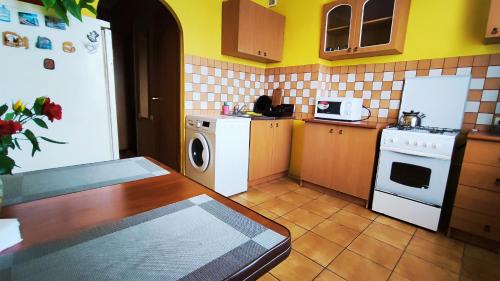 a small kitchen with a stove and a refrigerator at Василя Стуса 10 City Rooms in Bila Tserkva