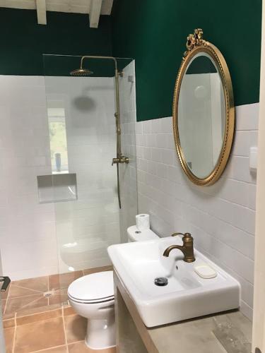 a bathroom with a sink and a toilet and a mirror at Monte Teu in São Luis