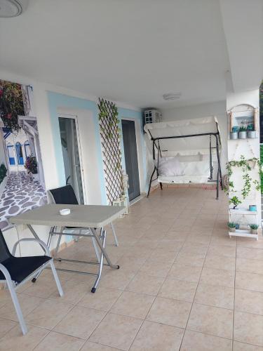 a living room with a table and a bed at Aegean Blue in Panteli