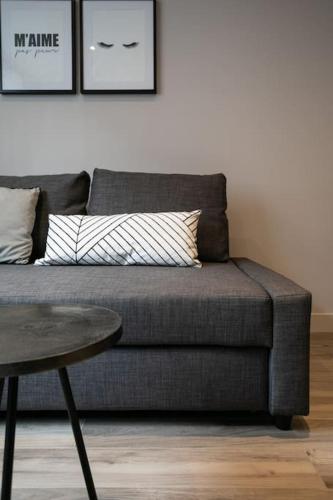 a couch in a living room with a table at 2 pieces proche metro, Montrouge in Montrouge