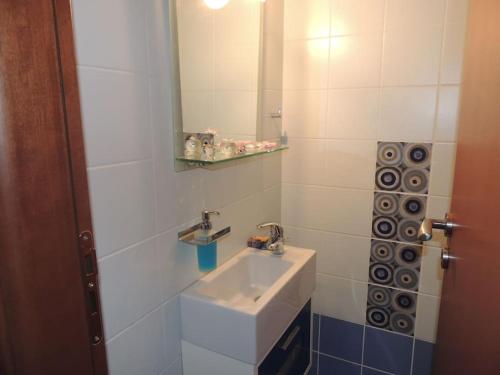 a bathroom with a sink and a mirror at Anastasias Villa in Kastro Kyllini