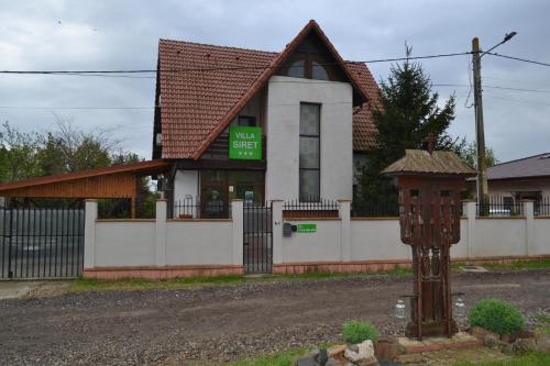 a building with a sign in front of it at Villa Siret in Galaţi