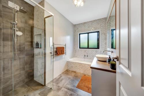 a bathroom with a shower and a sink at Velo Station in Porepunkah