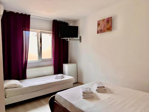 Postel nebo postele na pokoji v ubytování Casa Tin Ultracentral Costinesti