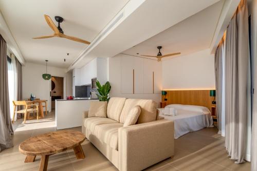 a living room with a couch and a table at Hotel Apartamentos Hamus in Conil de la Frontera