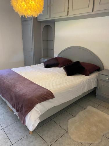 a bedroom with a large bed with pillows on it at Le Gîte au bord du Lac in Gérardmer