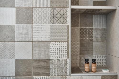 two bottles are sitting on a shelf in a shower at Luxurious house near the sea in Kato Daratso